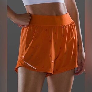 Lululemon Hotty Hot Short 4" in the Poco Logo Foil Amber Orange color